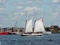 a 2 mast sailboat sails in the wind in Boston Harbor