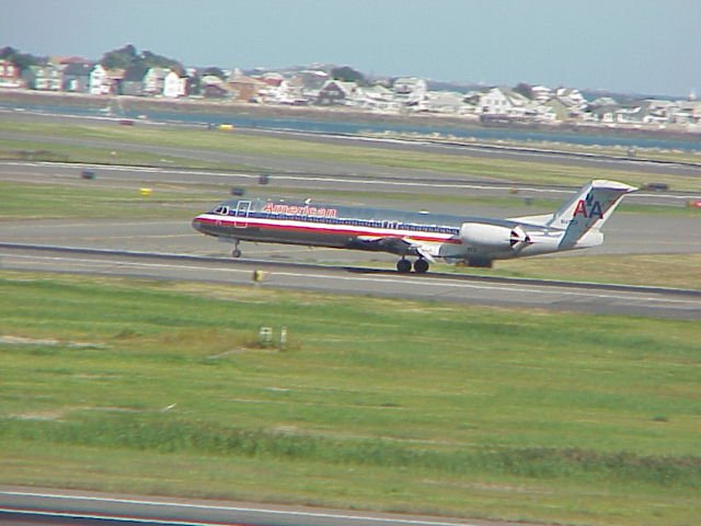 American Airlines jet youches down on a runway at Boston Logan International Airport