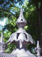 the cast iron cap on a fence pole at Bonston Public Gardens