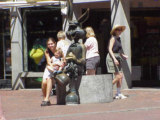 A mother and her young daughter pose for a photography with Bugs Bunny in Boston